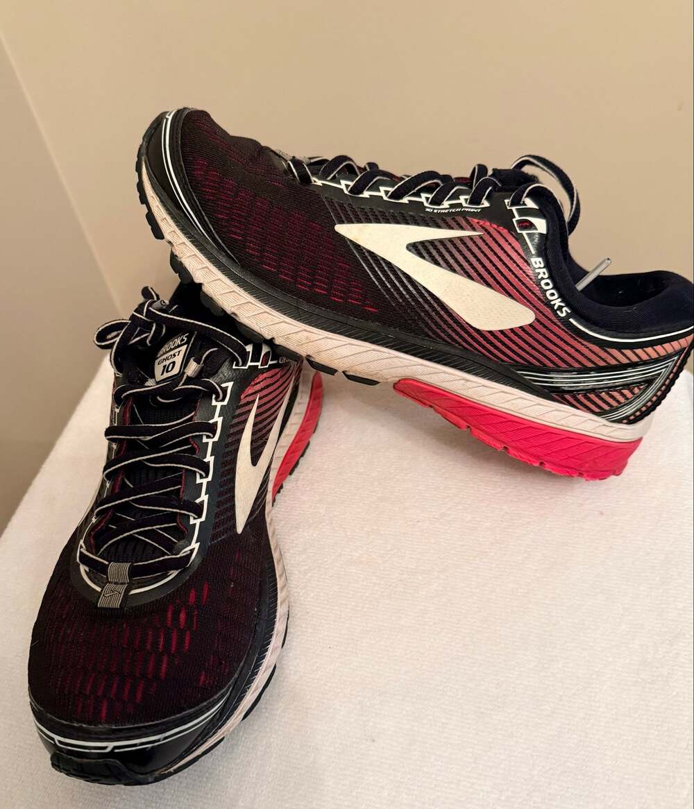 A pair of Brooks Ghost 10 women’s road running shoes Size 8.5 Black, pink,white.